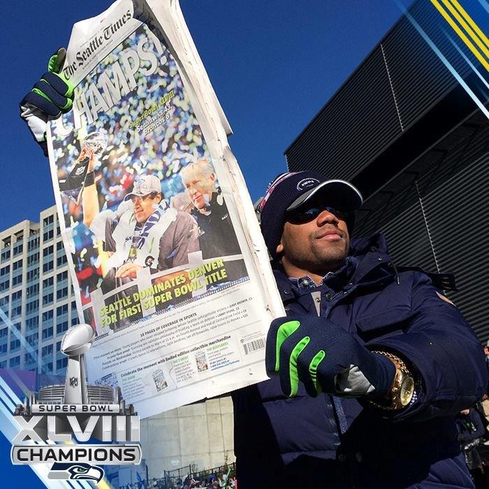 Seahawk Russell Wilson holding The Seatle Times printed with RBP